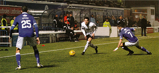 Kyle Magennis takes on the Queens' defence